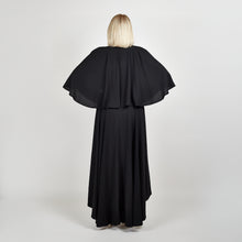 Load image into Gallery viewer, Back view of the Femponiq Bow Tie Neck Cape Sleeve Maxi Dress in Black showcasing its elegant bow tie neckline, flowing cape sleeves, and floor-length silhouette.