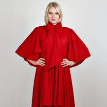 Load image into Gallery viewer, Close-up front view of the Femponiq Bow Tie Neck Cape Sleeve Maxi Dress in Deep Red, showcasing its elegant bow tie neckline, flowing cape sleeves, and floor-length silhouette.