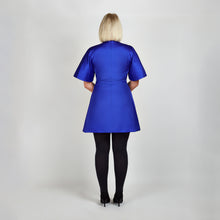 Load image into Gallery viewer, Back view of model in Femponiq Royal Blue Pleated Shoulder Kimono Sleeve Satin Duchess Dress, emphasizing the smooth satin finish and  flared structured skirt and sleeves.
