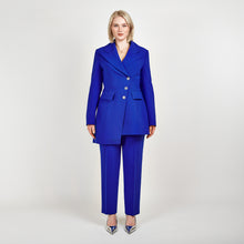 Load and play video in Gallery viewer, Video of a model wearing the Femponiq Asymmetric Double-Breasted Tailored Blazer in Royal Blue paired with matching High-Waisted Tailored Trousers, showcasing a sleek, elegant look.