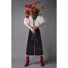 Load image into Gallery viewer, Model Is Wearing White Short Puff Sleeve Cotton Top And Holding Red Flowers - Front Side View
