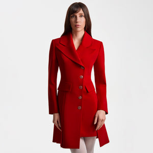 Front view of the Femponiq Asymmetric Pleated Blazer Dress in red, showing the wide peak collar, asymmetric button closure, padded shoulders, flap pockets and A-line tailored silhouette. The hand-crafted queen-motif buttons and clean pleats highlight the refined, structured design.