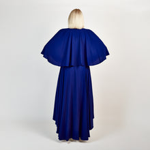 Load image into Gallery viewer, Back view of the Femponiq Bow Tie Neck Cape Sleeve Maxi Dress in Royal Blue, showcasing its elegant bow tie neckline, flowing cape sleeves, and floor-length silhouette.

