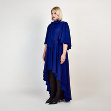 Load image into Gallery viewer, Side view of the Femponiq Bow Tie Neck Cape Sleeve Maxi Dress in Royal Blue, showcasing its elegant bow tie neckline, flowing cape sleeves, and floor-length silhouette.

