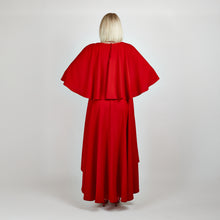 Load image into Gallery viewer, Back view of the Femponiq Bow Tie Neck Cape Sleeve Maxi Dress in Deep Red, showcasing its elegant bow tie neckline, flowing cape sleeves, and floor-length silhouette.


