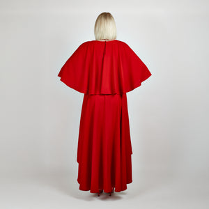 Back view of the Femponiq Bow Tie Neck Cape Sleeve Maxi Dress in Deep Red, showcasing its elegant bow tie neckline, flowing cape sleeves, and floor-length silhouette.


