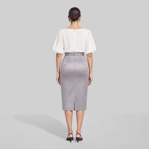 
FEMPONIQ pearl white vegan cupro blouse with voluminous elbow-length puff sleeves and a round neckline, shown on a model from the back.