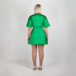 Back view of model in Femponiq Green Pleated Shoulder Kimono Sleeve Satin Duchess Dress, emphasizing the smooth satin finish and  flared structured skirt and sleeves.