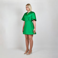 Load image into Gallery viewer, Side view of model in Femponiq Green Pleated Shoulder Kimono Sleeve Satin Duchess Dress, highlighting the graceful pleated shoulders and the flattering flared 
silhouette.
