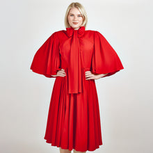 Load image into Gallery viewer, Close-up view of Femponiq&#39;s  Bow Tie Neck Ruched Midi Dress in scarlet red, featuring a chic bow tie neckline, elegant ruched detailing, and a flattering midi length, perfect for making a bold fashion statement.
