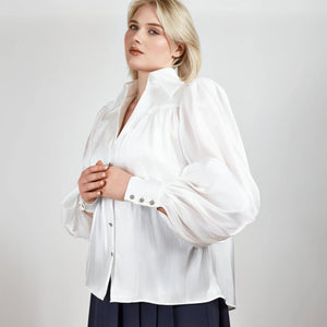 Close-up of the Femponiq Puff Sleeve V-Neck Gathered Shirt in Sheer White, focusing on the intricate gathered fabric, puff sleeve texture, and delicate sheer material.