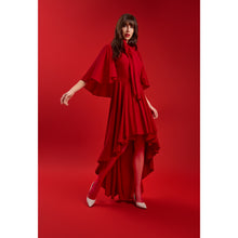 Load image into Gallery viewer, Model wearing the Femponiq Red Bow Tie Neck Cape Maxi Dress, featuring dramatic cape sleeves, an oversized bow neckline, and a high–low cascading hem for a luxurious, feminine silhouette.
