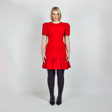 Load image into Gallery viewer, Model wearing the Femponiq Red Pleated Shoulder Peplum Hem Cady Dress, highlighting the sophisticated pleated shoulder detail and the flattering, feminine peplum hem. The dress enhances an hourglass figure with its sculpted silhouette, offering a timeless and elegant design.
