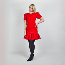 Load image into Gallery viewer, Another side view of model in Femponiq Red Pleated Shoulder Peplum Hem Cady Dress, highlighting the dress’s sleek silhouette, pleated shoulder sleeves and feminine peplum accent. 
