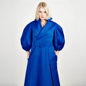 Close-up front view of Femponiq’s Wide Lapel Asymmetric Belted Midi Cotton Dress in a vibrant blue hue, showcasing the stylish wide lapels, asymmetrical hemline, side slit pockets and flattering belt that accentuates the waist.
