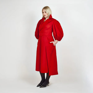Side view of Femponiq’s Wide Lapel Asymmetric Belted Midi Cotton Dress in vibrant red, showcasing its stylish wide lapels, unique asymmetric design, side slit pockets and a belted waist that enhances the silhouette.