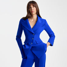 Load image into Gallery viewer, Cropped view of a model wearing bright blue high-waisted tailored trousers with pressed front pleats, paired with a matching structured blazer. The Femponiq trousers feature a sleek long-leg silhouette, functional belt, concealed snap fastening, and slash pockets, creating a polished and modern look.
