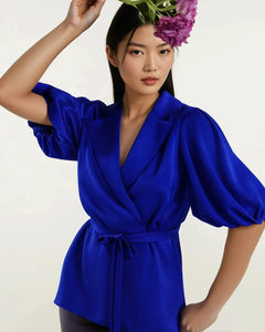Model wearing Femponiq royal blue belted puff sleeve sateen top with puffed sleeves on a white background