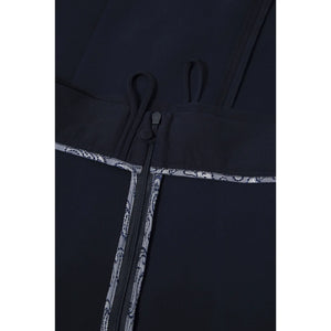 Close-up view of the inner waist and zip of the Femponiq High-Waisted Pleated Midi Skirt, showcasing bounded contrast parsley lining for a refined finish.