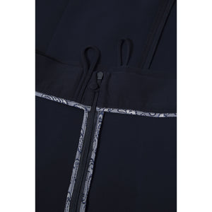 Close-up view of the inner waist and zip of the Femponiq High-Waisted Pleated Midi Skirt, showcasing bounded contrast parsley lining for a refined finish.
