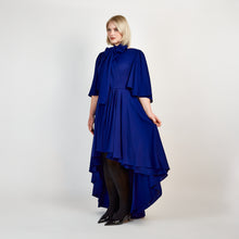 Load and play video in Gallery viewer, Video of a model wearing the Femponiq Bow Tie Neck Cape Sleeve Maxi Dress in Midnight Blue, highlighting its flowing silhouette and elegant bow tie neckline.
