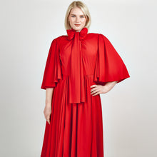 Load and play video in Gallery viewer, Video of a model showcasing the Femponiq Bow Tie Neck Pleated Midi Dress in Scarlet Red, featuring a flattering gathered midi design and elegant bow tie neckline.
